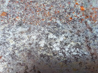 Abstract background of an old, weathered metal surface with prominent rust and texture.