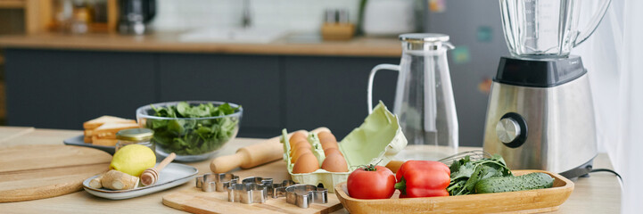 Kitchen counter with fresh vegetables and cooking ingredients for breakfast preparation