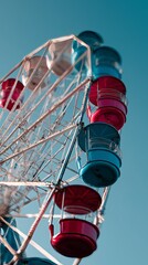 Vibrant blue and red Ferris wheel cabins set against a clear blue sky, evoking a sense of fun and nostalgia.