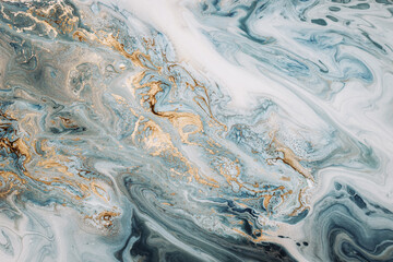 Abstract acrylic fluid texture in blue tones and golden splashes