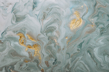 Abstract acrylic fluid texture in blue tones and golden splashes