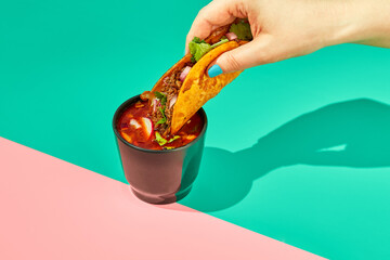 Traditional mexican birria ramen consomme soup and tacos with braised beef. Dip tacos in broth.