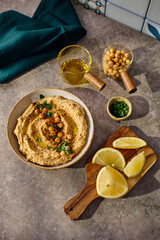 Delicious hummus with olive oil, chickpeas and parsley. Top view.