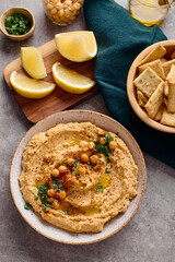 Delicious hummus with olive oil, chickpeas and parsley. Top view.