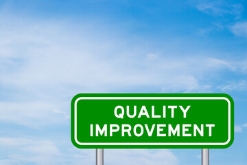 Green color transportation sign with word quality improvement on blue sky with white cloud background