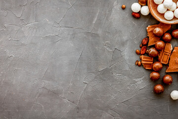 Sweets background with chocolate praline balls on grey desk top-down frame copy space
