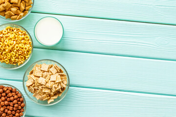 Cereals and flakes from corn and oat on mint wooden background top view mockup