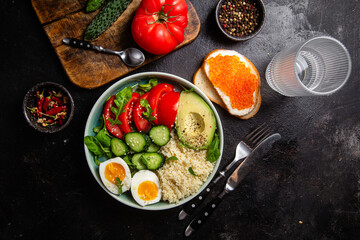 Couscous with boiled egg and vegetables in a plate on the table
