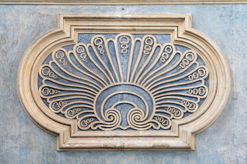 Close-up on decorative abstract sculpture carved in marble wall of italian historic building