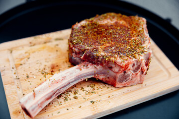 Seasoned tomahawk steak ready for grilling