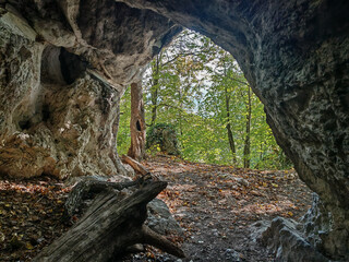Looking out from inside the Sólyom-kút cave toward the forested slopes of the Bükk Mountains. A...