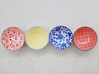 The round ceramic bowl has an oriental decorative motif.