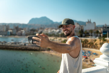 Blogger capturing scenic beach view with smartphone