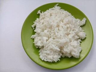 Steamed rice on plate isolated on white background. Carbohydrate menu