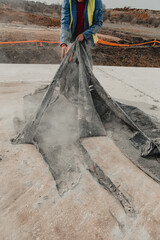 Professional Construction worker meticulously lays concrete, ongoing construction are