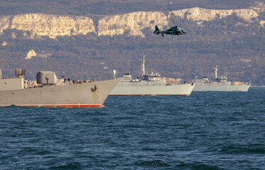 A formation of warships and copter sail in the Black Sea during a peacekeeping operation.
