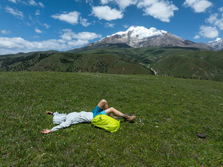 Backpacking woman hiking on grassland mountains