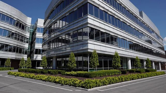 Modern office building exterior with reflective windows in urban setting at daytime