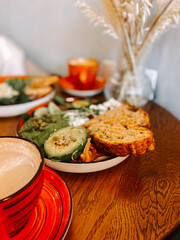 Breakfast spread featuring healthy dishes and coffee in a cozy cafe setting