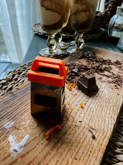 Creative dessert preparation with chocolate and citrus zest on a wooden board in natural light