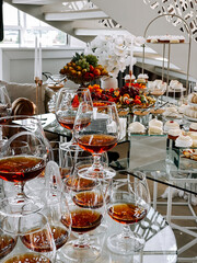Elegant dessert display with beverages at a modern event venue overlooking the city