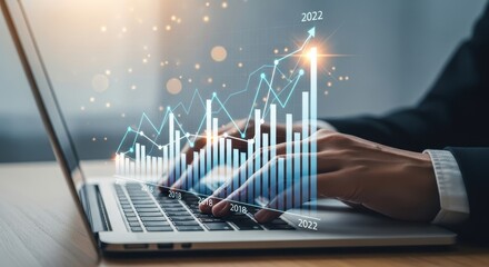 Close-up of hands typing on a laptop with financial graphs overlaid, suggesting business growth.