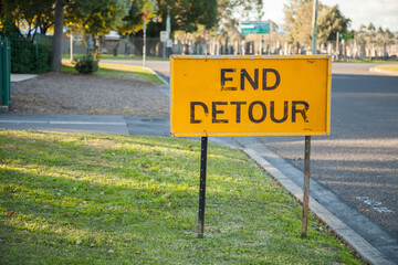 Bright end detour sign beside the road