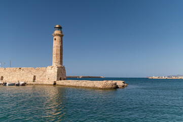 Historic lighthouse stands proud by the calm waters of Rethymno, Crete, Greece