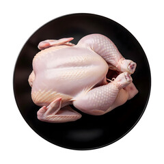A raw whole chicken on a black plate isolated on transparent background, ready for cooking and culinary preparation for dinner