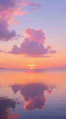 Fototapeta premium Serene Sunset Reflection with Pink Clouds Over Calm Water