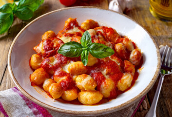 Delicious Italian gnocchi served with rich tomato sauce, mozzarella and grated cheese