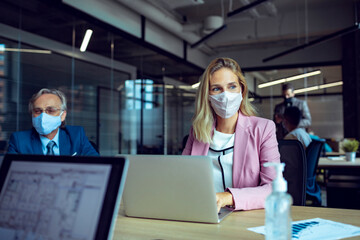 Business meeting with face masks in modern office during pandemic
