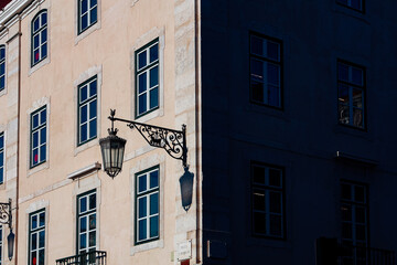 Harsh light and shadow from people and objects in the city