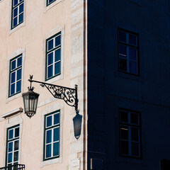 Harsh light and shadow from people and objects in the city
