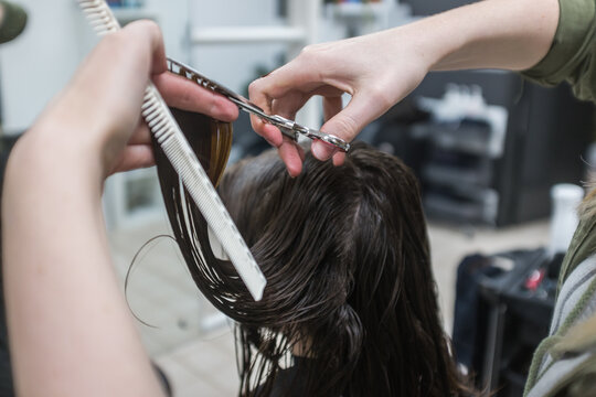 Detail of teenager getting a haircut at the hairdresser