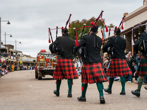 Pipers marching along a street