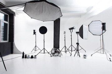 Professional cyclorama photo studio setup with lighting equipment and backdrop