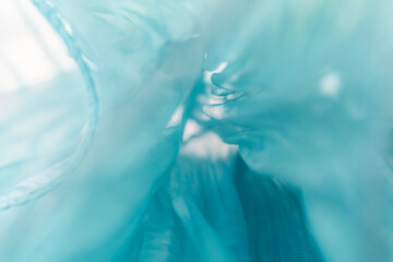 Flowing Light Blue Semi-Transparent Fabric Close-Up – Soft Draped Texture for Fashion, Textile...