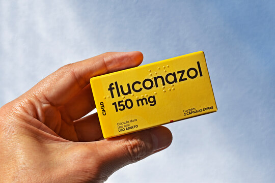 RIO DE JANEIRO, BRAZIL - June 30, 2025: Hand holding a box of fluconazole 150 mg