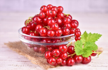 Red currant berries in a glass bowl. Close-up.