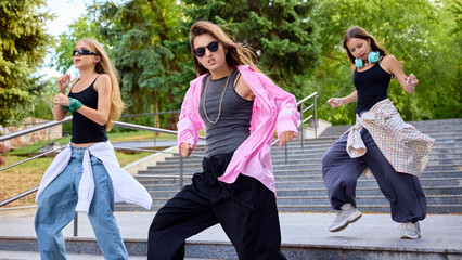 Street geometry. Dynamic group of diverse young street dancers performs energetically on urban...