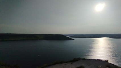 Scenic River Bend with Green Hills and Clear Blue Sky in Summer