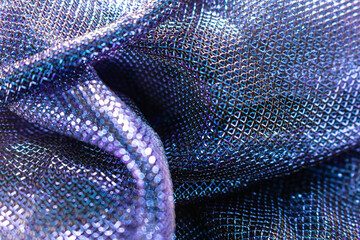 Close-Up of Iridescent Metallic Mesh Fabric in Blue and Purple Tones – Reflective, Textured...