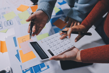UX UI designer testing prototype on a phone, discussing and brainstorming on wireframes for a...