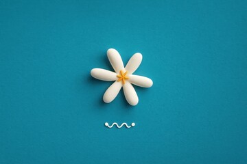 White flower is placed on a blue background