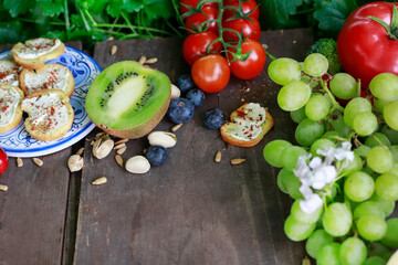 Pomegranate, kiwi, grapes and other fruits on a tray.