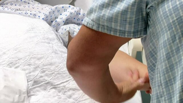 Nurse drawing blood from patient in hospital 