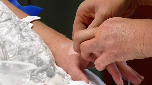 Nurse drawing blood from patient in hospital 