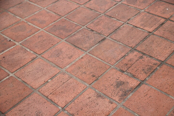 
Red square ceramic floor with mold seen from a diagonal perspective