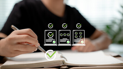 Hand writing checklist in notebook with digital task icons, concept of productivity, planning, task management, and personal organization.